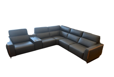 A modern gray leather sectional sofa with an L-shaped design, featuring adjustable headrests and a built-in console with cup holders, set against a white background.