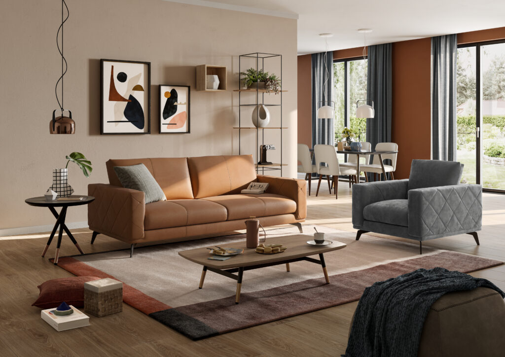 Contemporary living room with a brown leather sofa, gray armchair, and abstract wall art. Bright and airy with large windows and dining area.